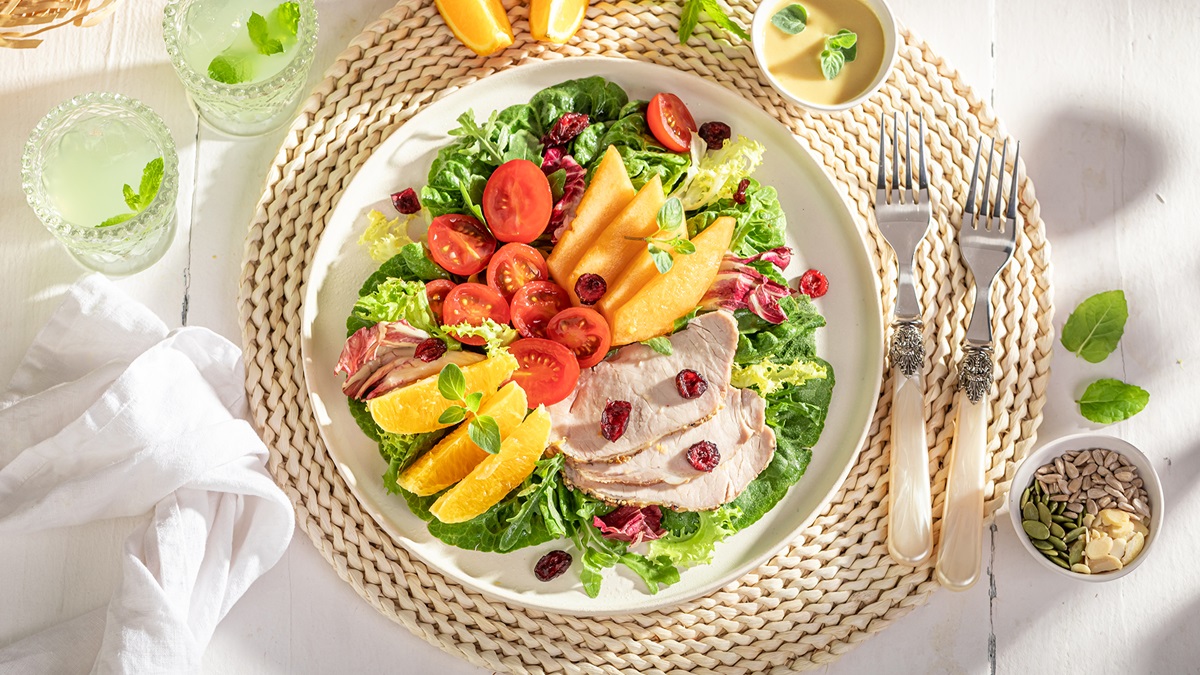 A colorful table spread showing healthy and easy summer dinner recipes for family featuring grilled veggies, salads, and fresh ingredients